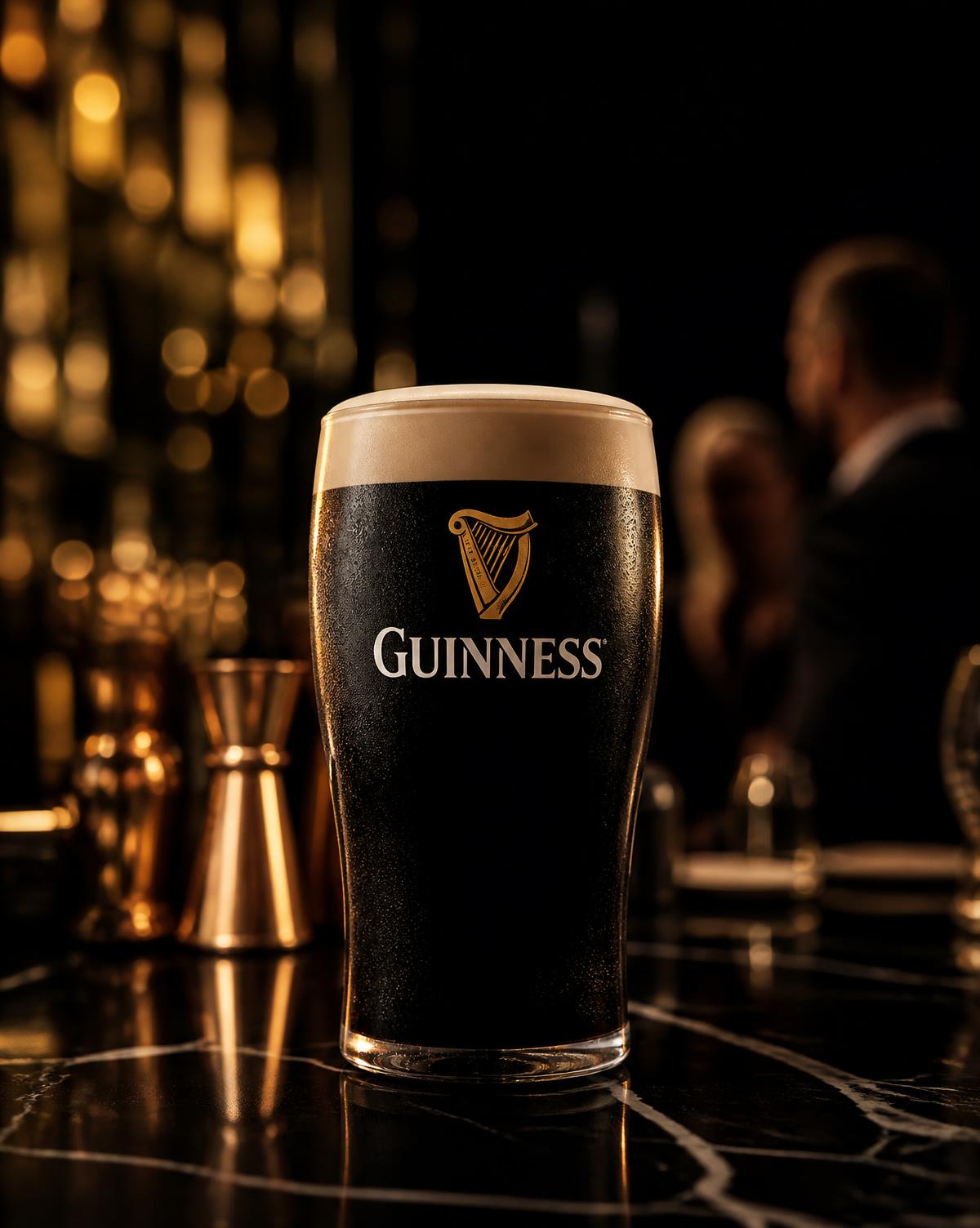 A pint of Guinness on a dark marble bar at an evening reception